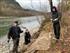 Two WCC crew members, Maia Kattenbraker (left) and  Mary Hemminger (right) working with Tori, our Stewardship AmeriCorps (center) to install the live fascine over erosion control fabric.